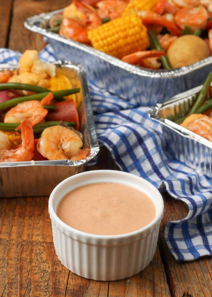 Vertical shot of bowl of Cajun Dipping Sauce and shrimp and vegetables