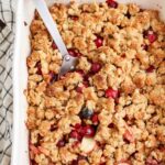 cranberry crisp with apples and large serving spoon