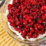 cranberry jalapeno mixture over cream cheese in dish with crackers