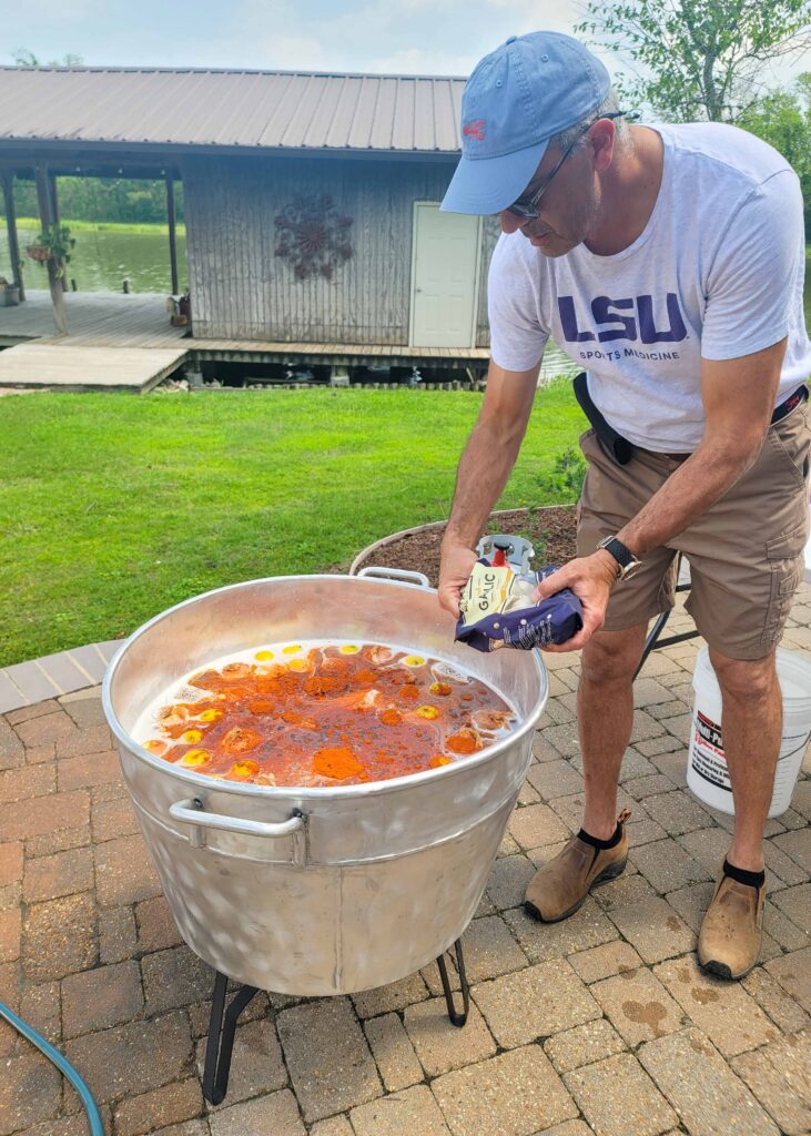 garlic being added to Louisiana boil