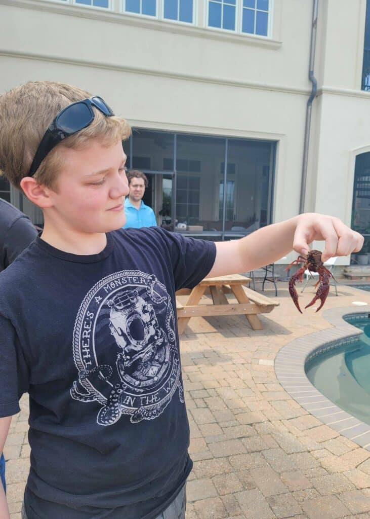 child holding crawfish