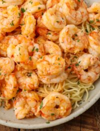 Overhead shot of garlic butter shrimp and buttery pasta in a white dish