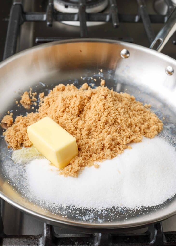 Overhead shot of butter and sugar in a stainless steel skillet