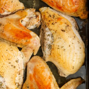 roast turkey sections in pan